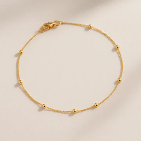 close-tornozeleira-com-bolinhas-douradas-acabamento-fino-zarelle
